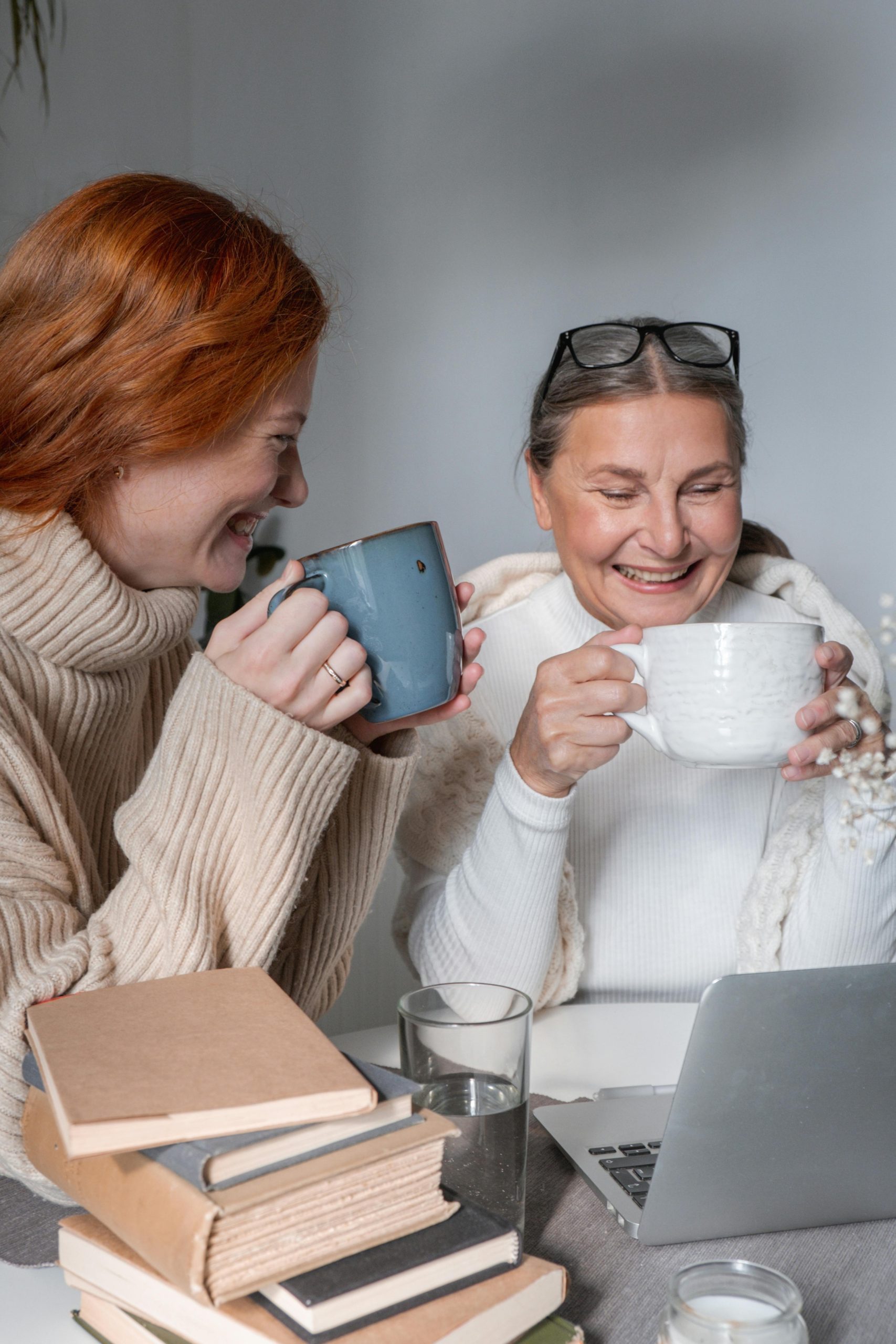 Home A heartwarming moment of a mother and daughter sharing coffee at home, radiating warmth and togetherness.